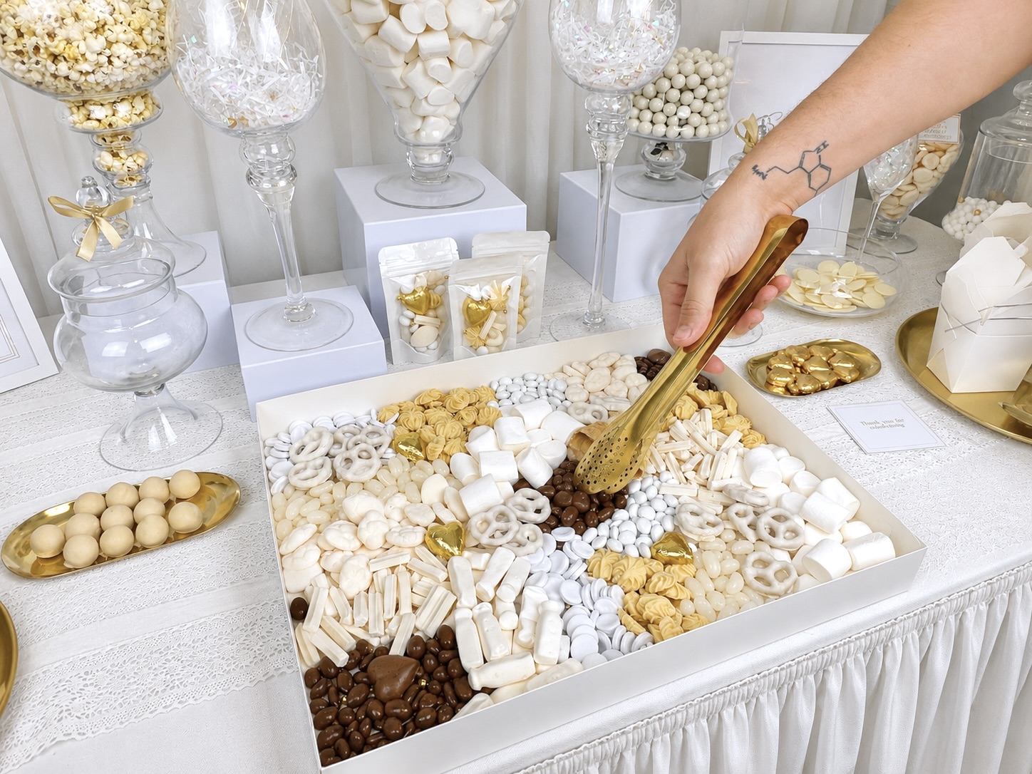 Luxury dessert bar styled in blush and gold with macarons, mini cakes and gelato