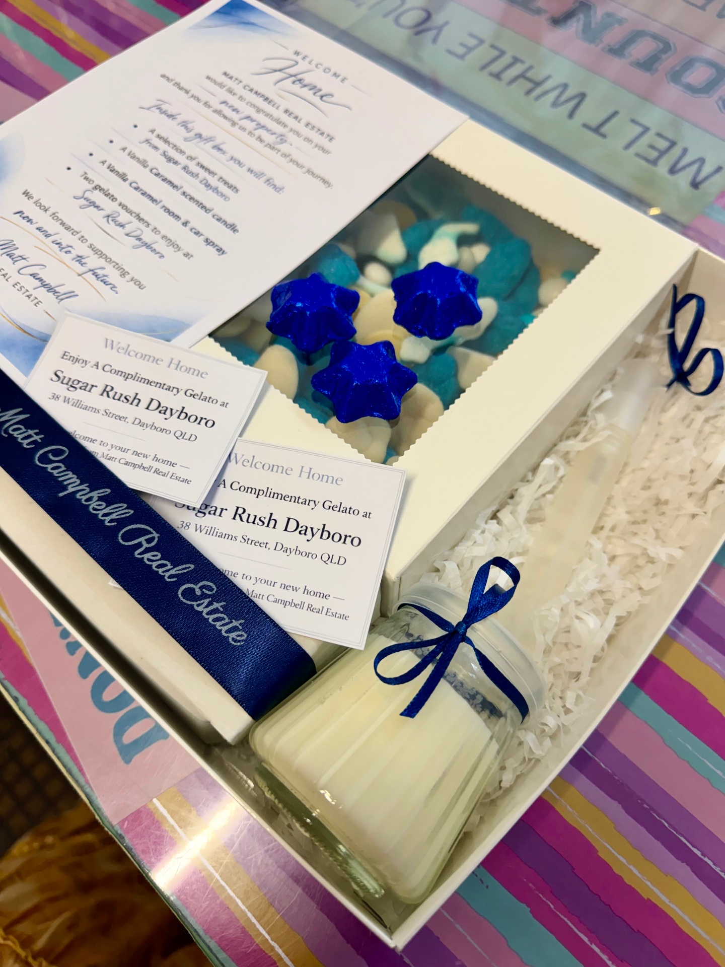 Matt Campbell Real Estate Welcome Home branded gift box with blue star chocolates, candle and complimentary gelato voucher